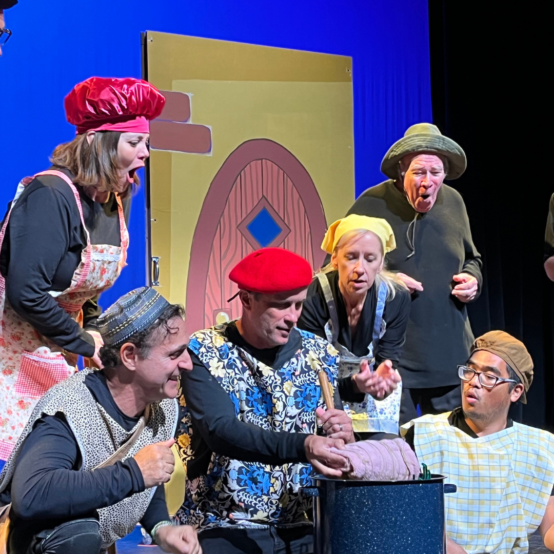 drama performance featuring actors in colorful dress at the Newhall theatre