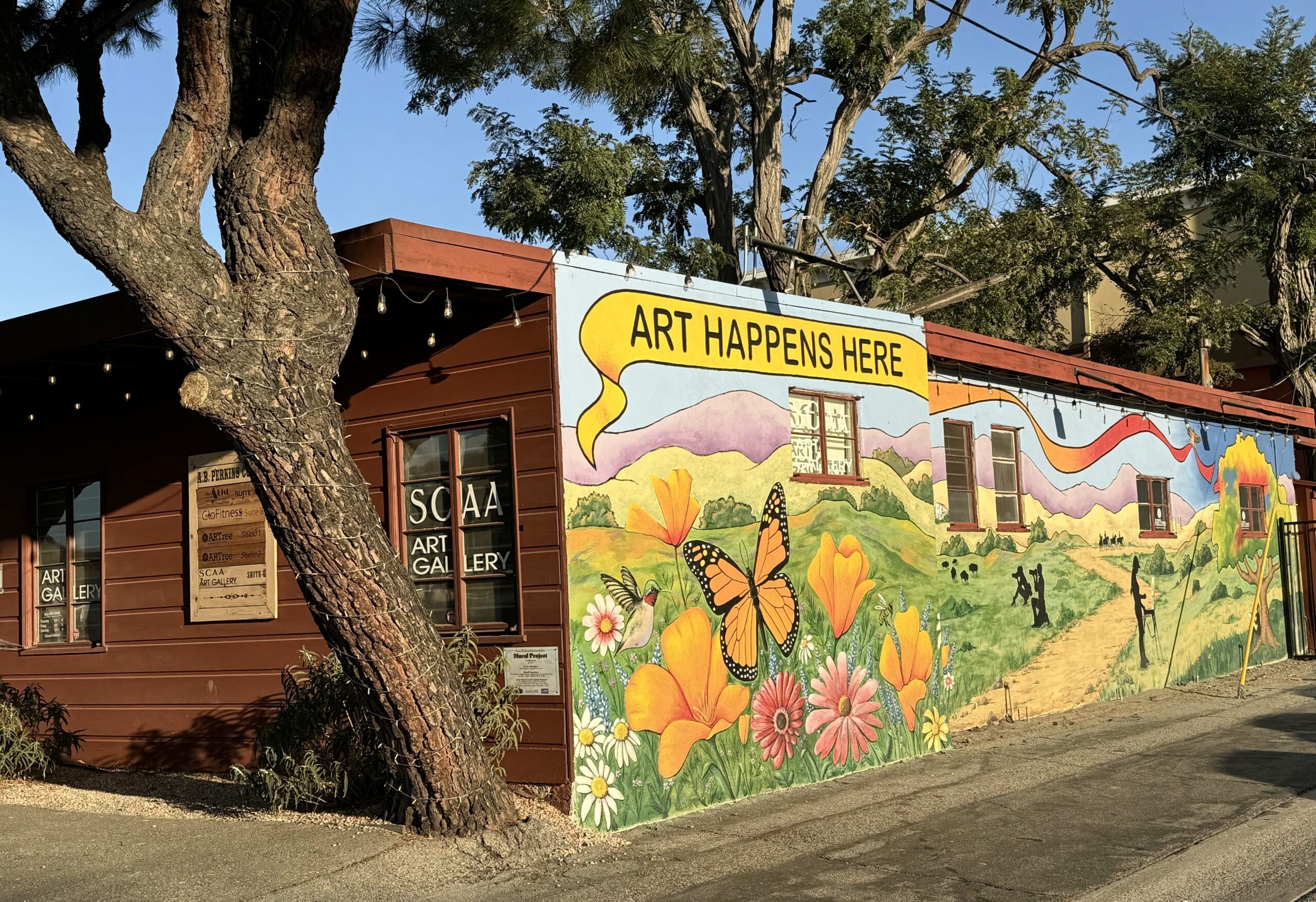 A beautiful Mural featuring a monarch butterfly and poppy flowers on the Storefront of the Santa Clarita Artists Association (SCAA) building