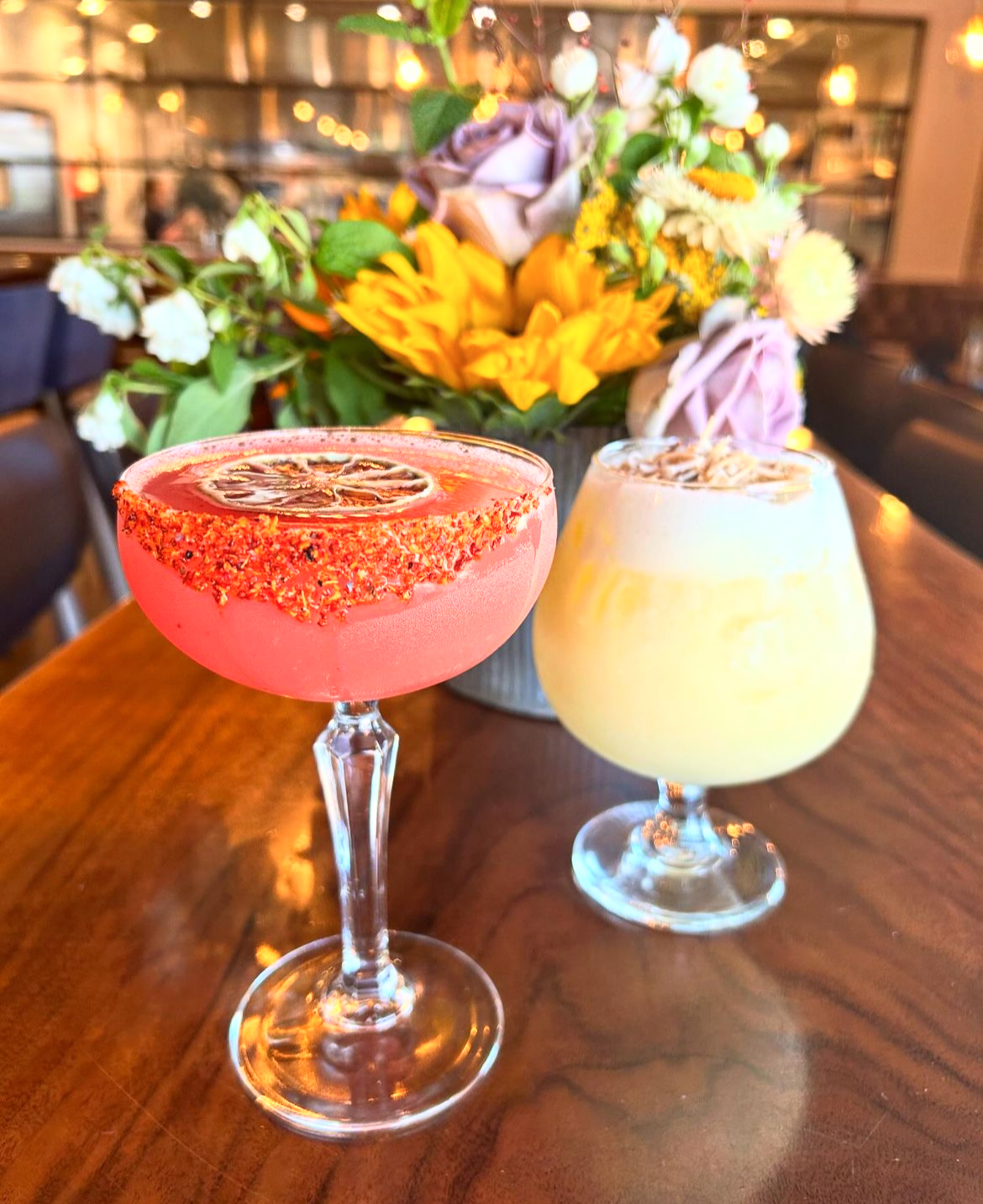 Classy strawberry margarita and coconut piña colada against a floral backdrop at Old Town Junction