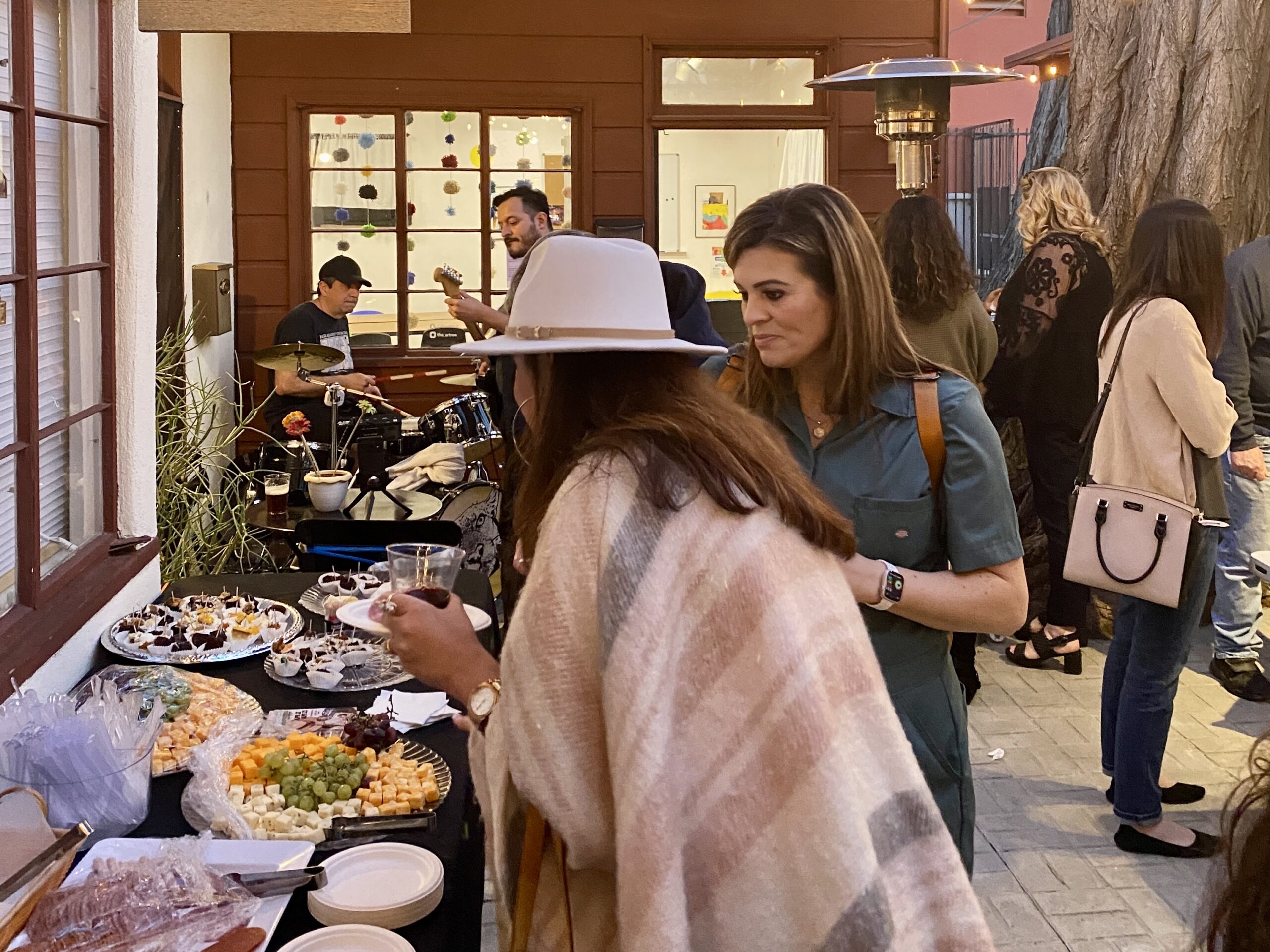 Outdoor Event held at the Santa Clarita Artists Association, featuring live music, cheese and meat samplers, and heating lamps