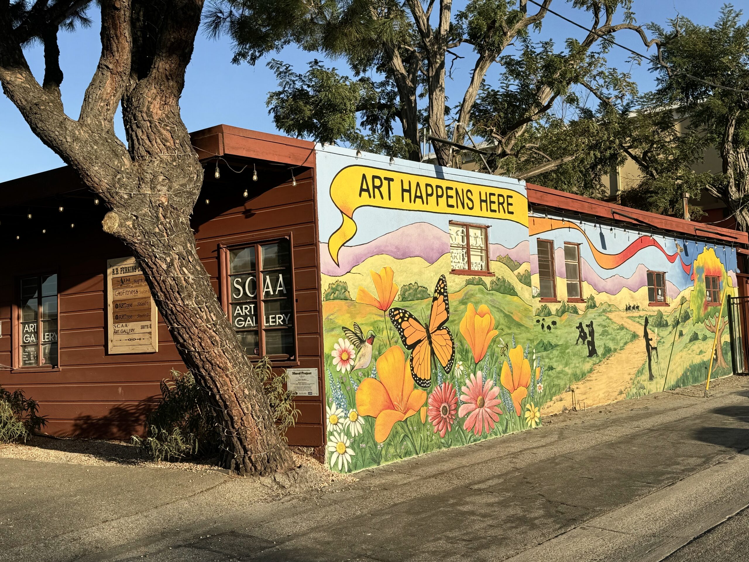 A beautiful Mural featuring a monarch butterfly and poppy flowers on the Storefront of the Santa Clarita Artists Association (SCAA) building