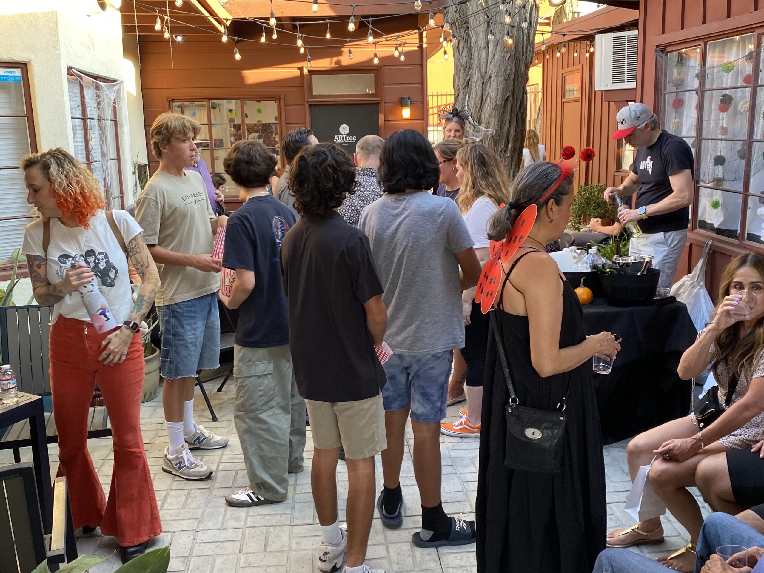 Guests attending a gallery showing, featuring wine tasting at the Santa Clarita Artists Association, a fun event held in Old Town Newhall